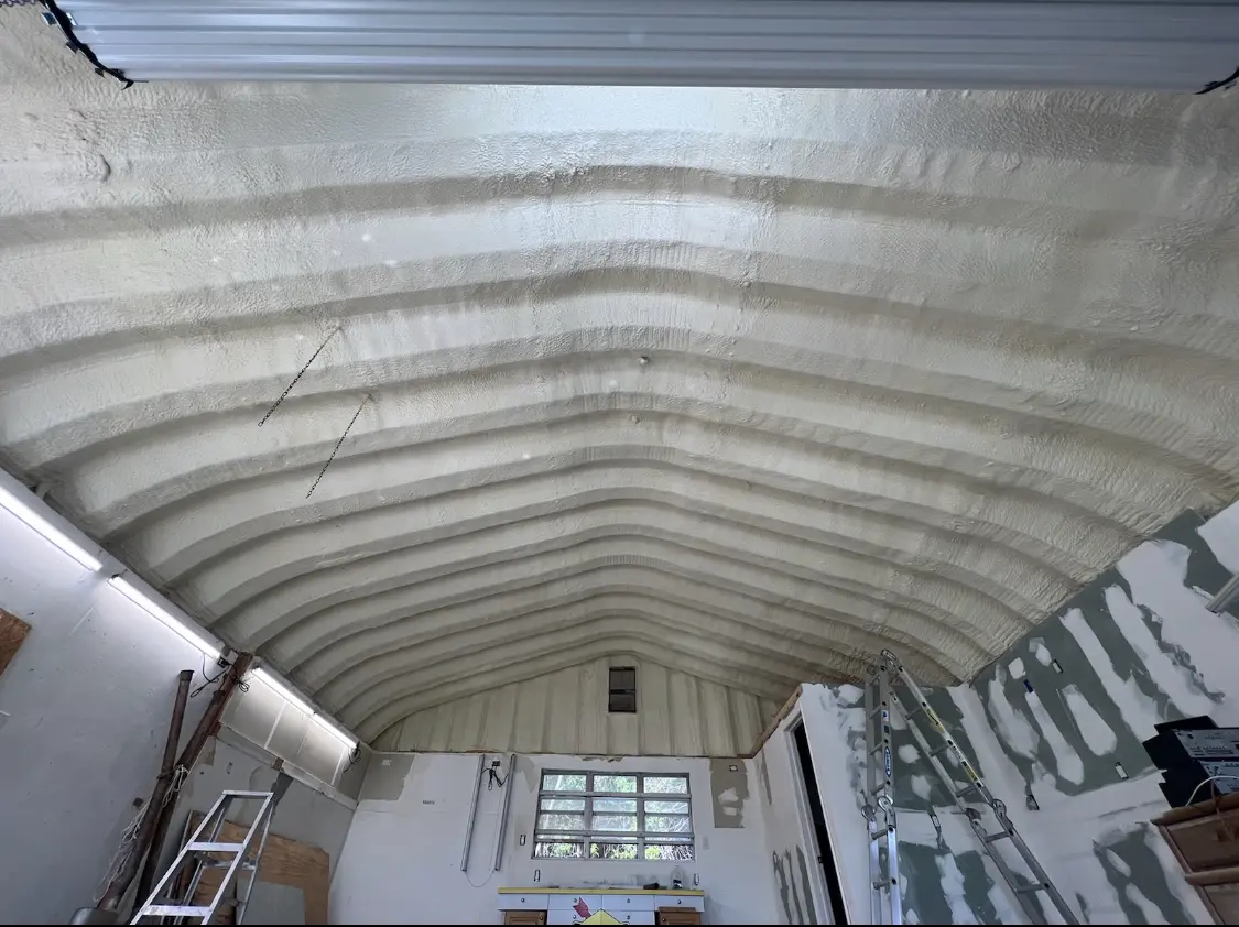 Spray polyurethane foam applied to the underside of a metal roof deck in Lackland AFB